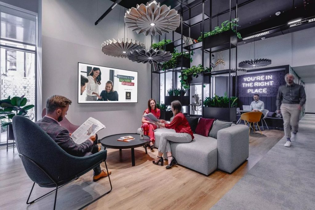 People sitting on sofas, reading and talking in MyHive Nimbus Flex