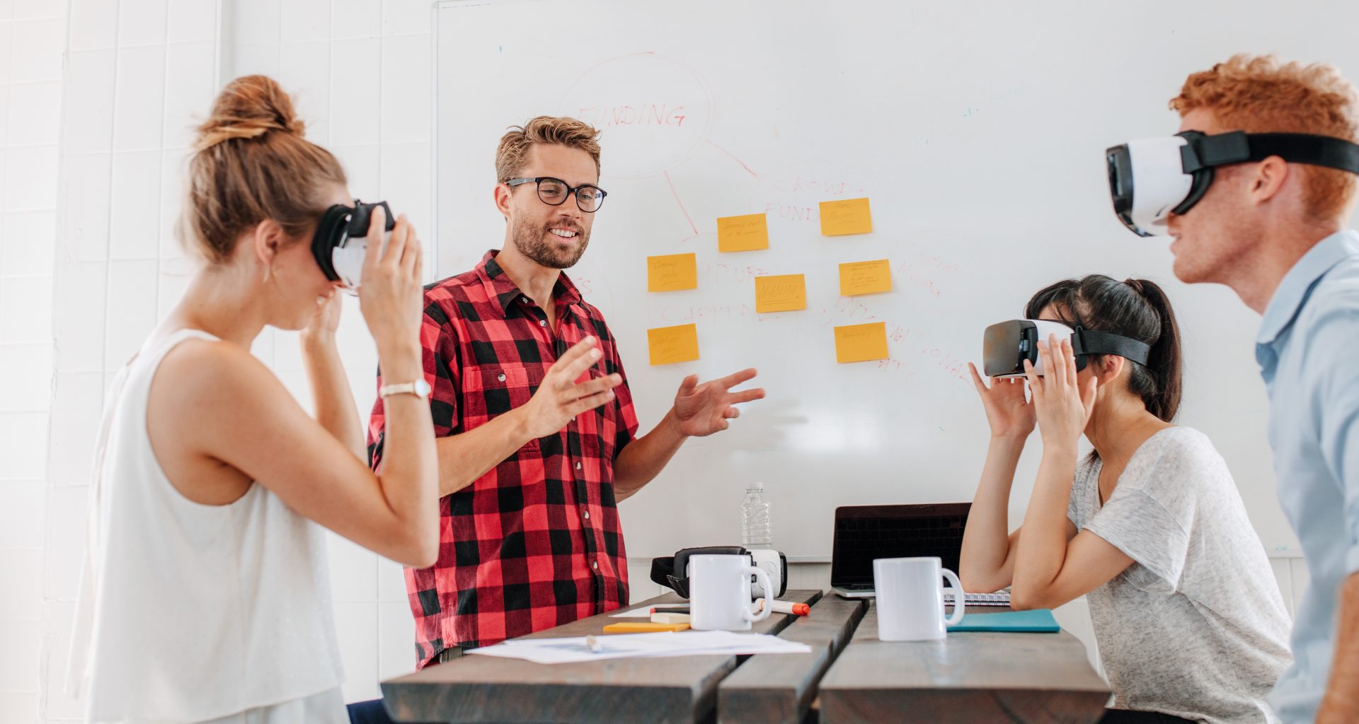 Business people using virtual reality goggles during meeting